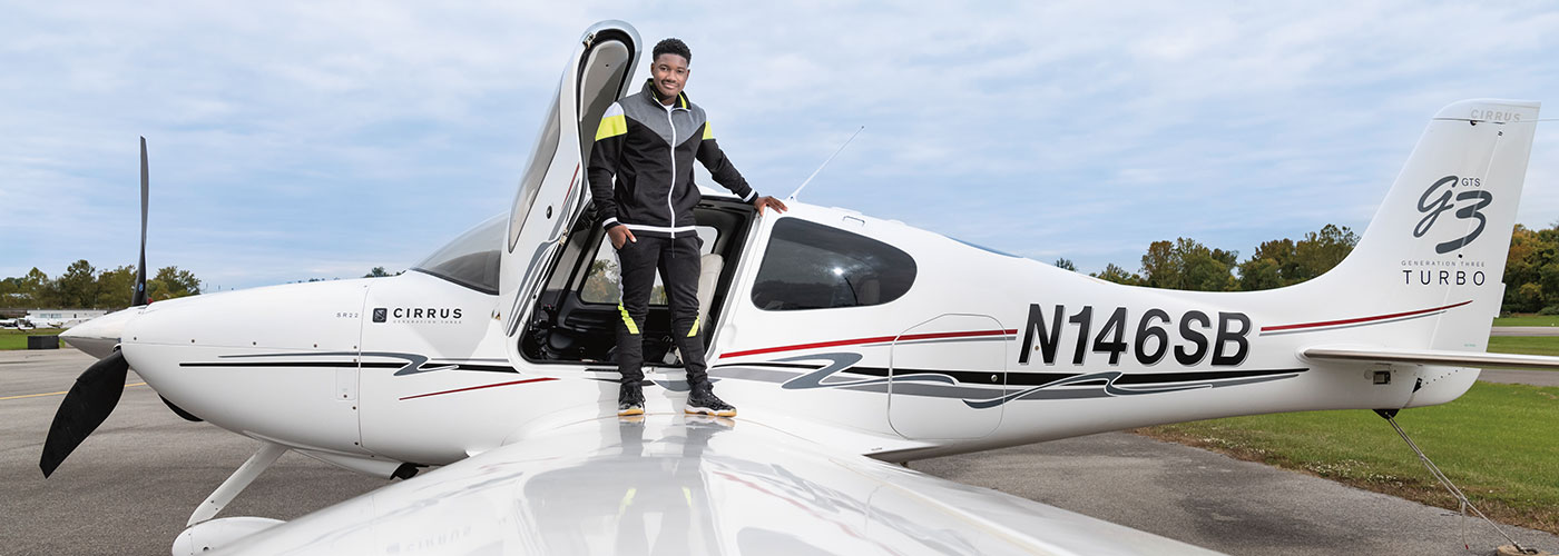 Photo of a person standing on wing of a small plane